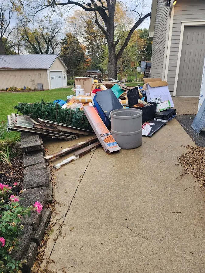 Dumpster being loaded with debris for Commercial Dumpster Rental in Evans